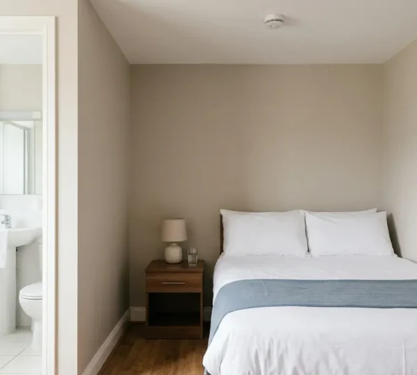 A professionally cleaned budget hotel room showing attention to hygiene standards and safety features