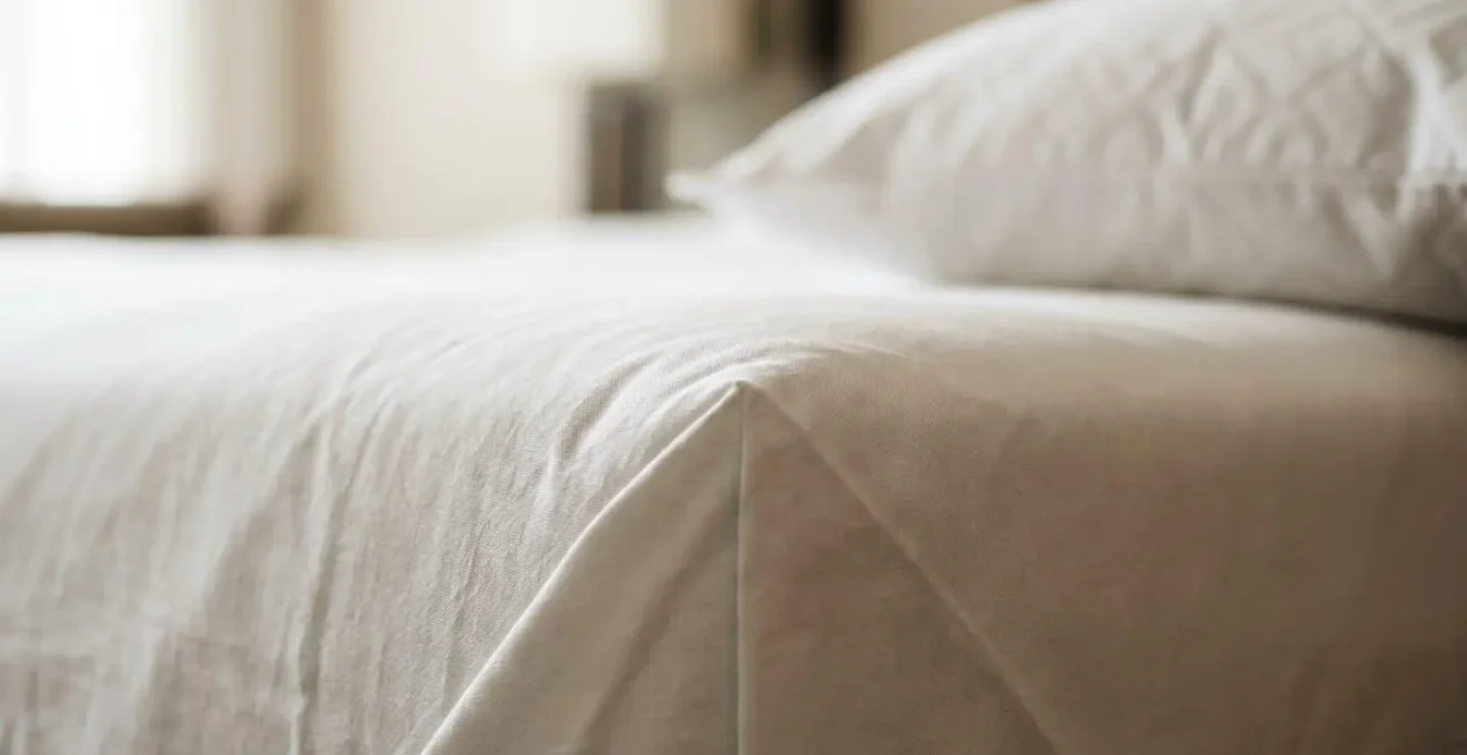 Close-up macro view of pristine hotel room textile details demonstrating professional housekeeping standards
