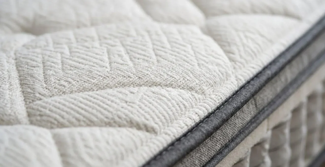 Close-up detail of premium hotel mattress surface showing supportive layered construction